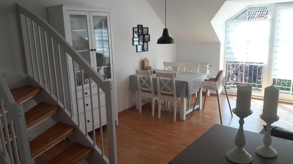 a kitchen and dining room with a table and chairs at OstseeNest in Schönhagen