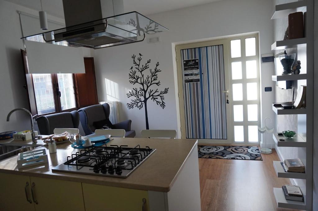 a kitchen with a stove top oven in a room at Lucky's Home in Enna