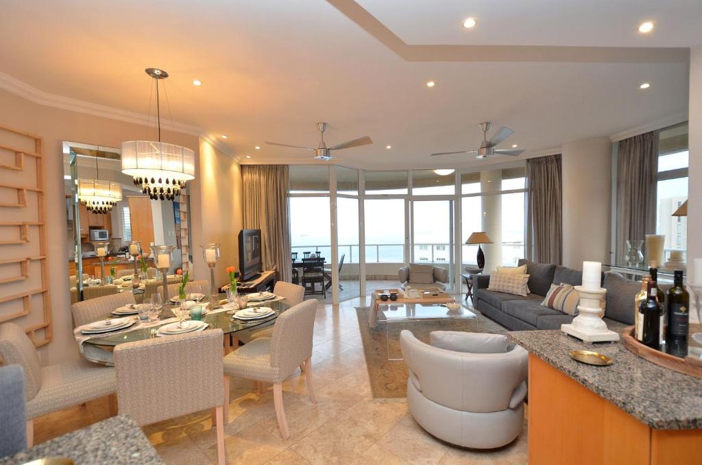 a living room with a couch and a table at 703 Oyster Schelles - by Stay in Umhlanga in Durban