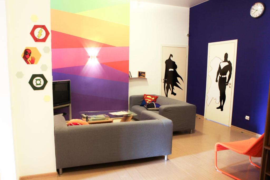 a living room with a couch and a colorful wall at Super Hostel in Irkutsk