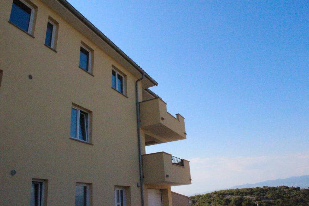 a building with boxes on the side of it at Apartmani Marin in Vrbnik