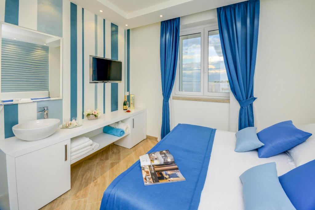 Posteľ alebo postele v izbe v ubytovaní Hotel Villa Garuti