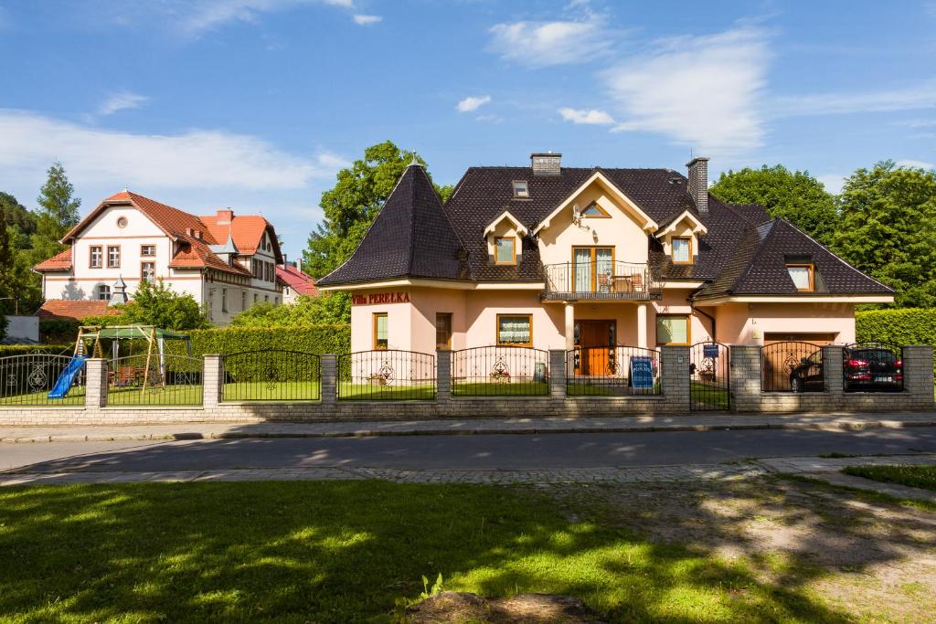 a large house with a black roof at Willa Perełka in Kudowa-Zdrój