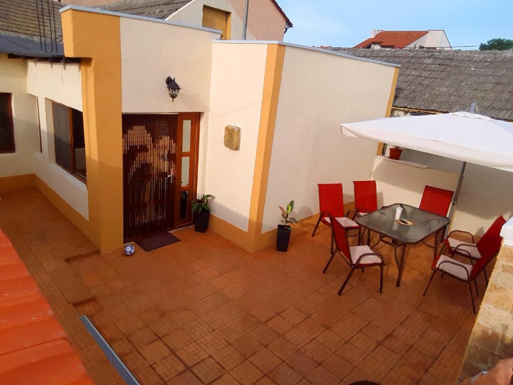 a balcony with a table and chairs on a house at Casa Albert in Constanţa