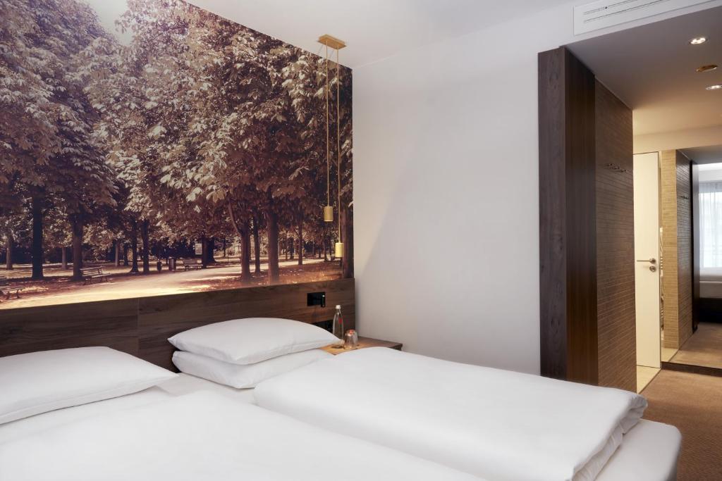 Postel nebo postele na pokoji v ubytování HYPERION Hotel Berlin