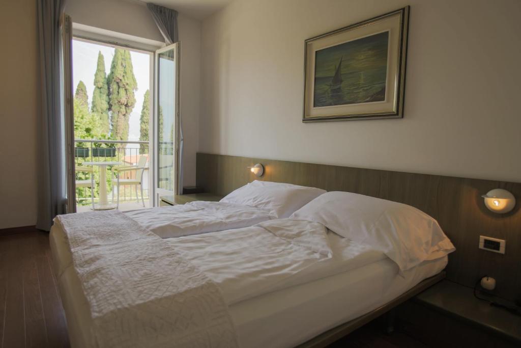 Postel nebo postele na pokoji v ubytování Hotel Al Caval