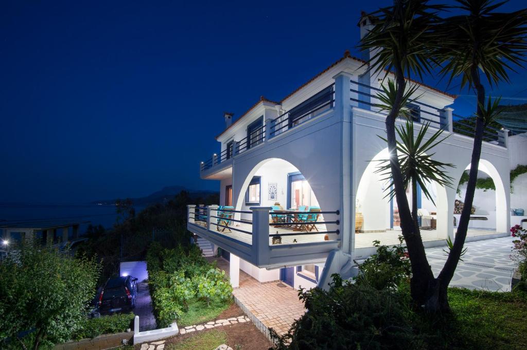 a villa with a view of the ocean at night at Blue Dream villa a seaside beauty in Euboea island in Platána