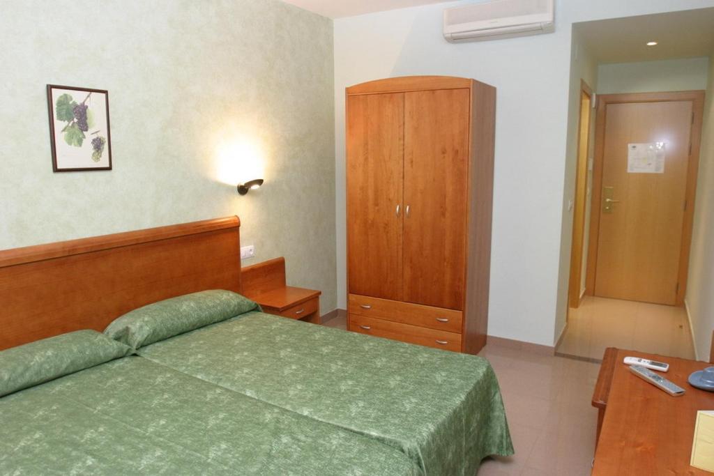 Postel nebo postele na pokoji v ubytování Hotel Fonda Neus