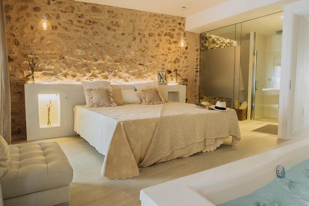 a bedroom with a bed and a tub in a room at Can Solaies in Sant Llorenç des Cardassar