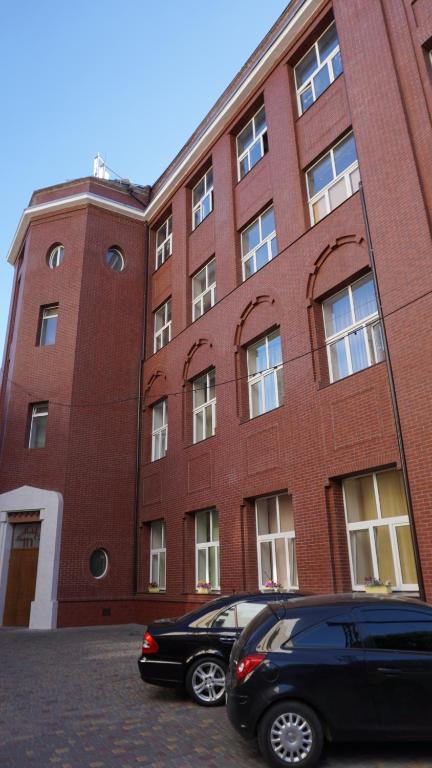 a black car parked in front of a brick building at Happy Cat in Odesa