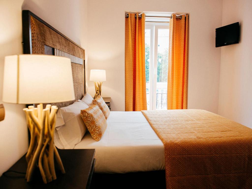 a bedroom with a bed with a lamp and a window at Apartamentos Art Suite Santander in Santander