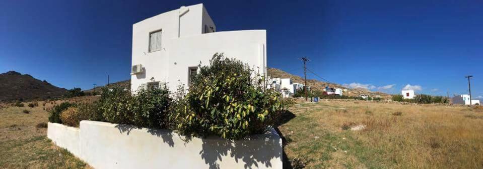 a white building on top of a field at Gaia Serifos Apartments in Rámos
