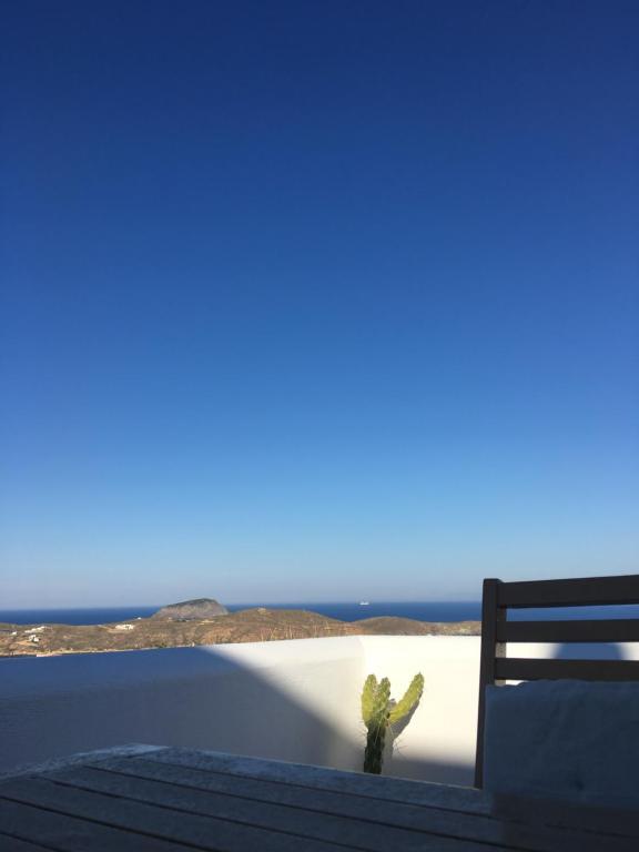 a cactus sitting on top of a balcony with the beach at Gaia Serifos Apartments in Rámos