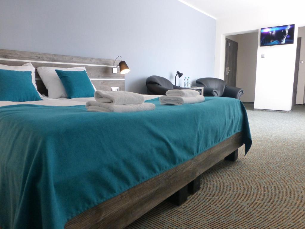 Posteľ alebo postele v izbe v ubytovaní Hotel Giżycko