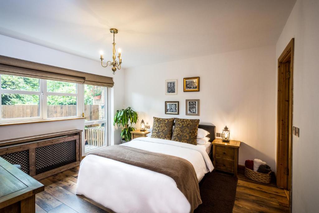 a bedroom with a large bed and a fireplace at Rose Cottage B&B in Swords