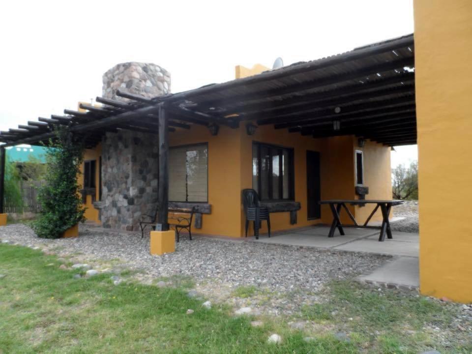 a house with a patio with a table in front of it at Cabanas Villa Santa Clara del Atuel in San Rafael