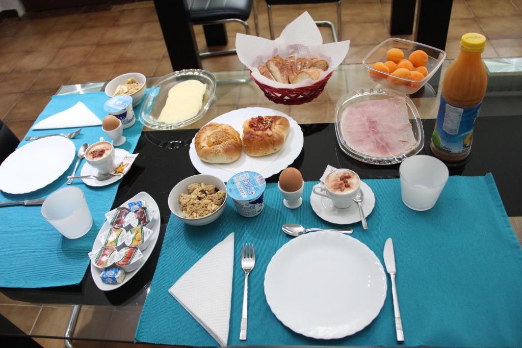 a table with plates of food on a table at B&B Villa Adriana in San Leone