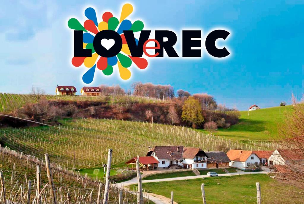 a sign that saysoviore on a hill with houses at Tourist Farm Rooms Lovrec in Jiršovci