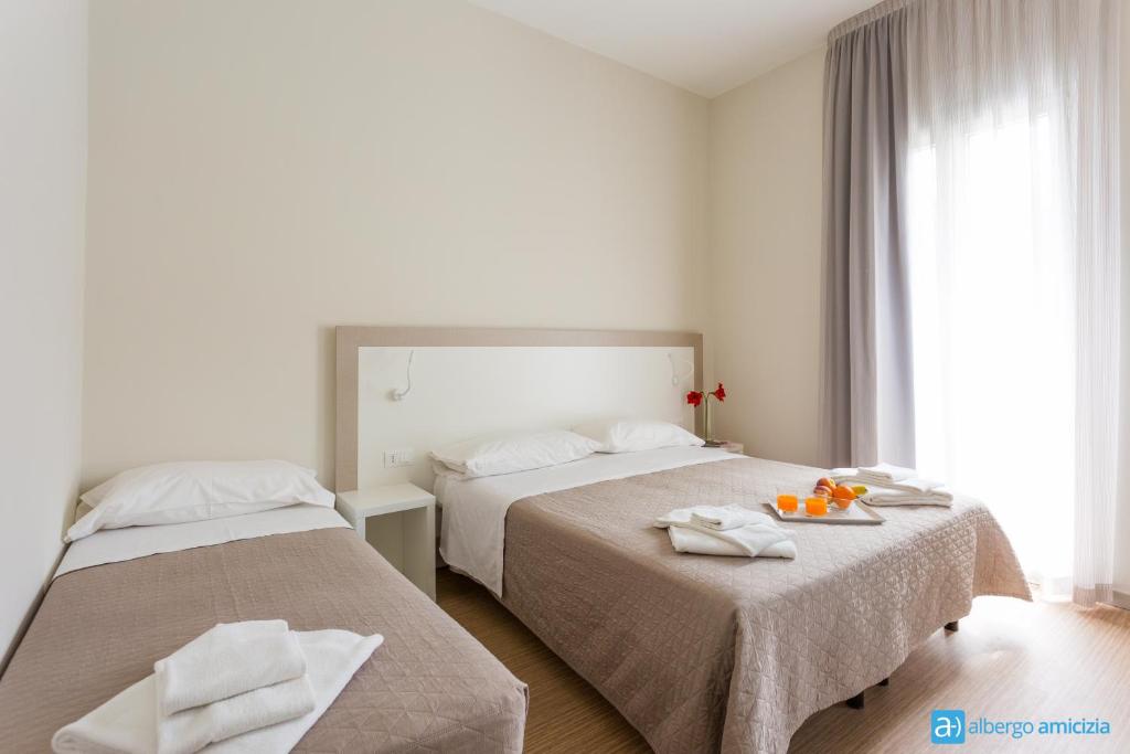 Postel nebo postele na pokoji v ubytování Hotel Amicizia