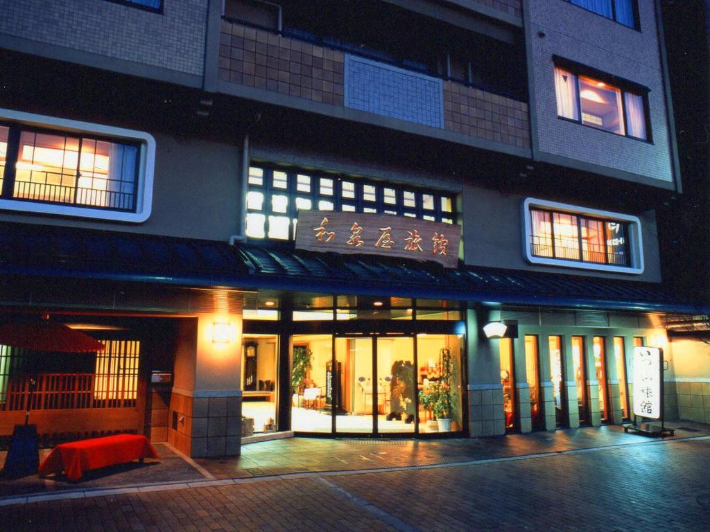 a building with a lot of windows at night at Izumiya Ryokan in Kyoto