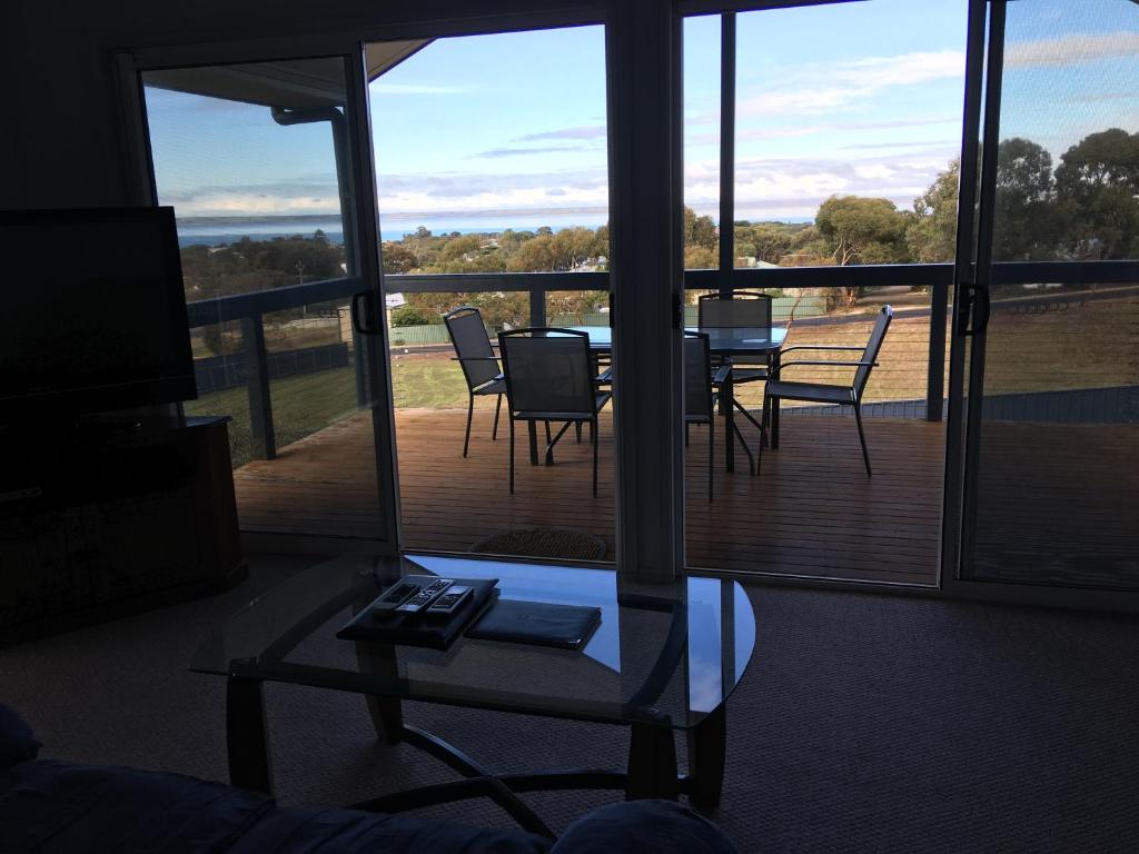 a room with a balcony with a table and chairs at Kangaroo Island Bayview Villas in Kingscote