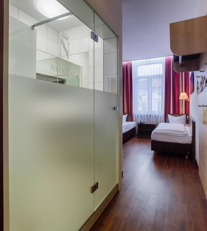 Postel nebo postele na pokoji v ubytování Hotel National