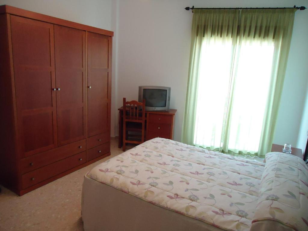 Postel nebo postele na pokoji v ubytování Hostal Los Claveles