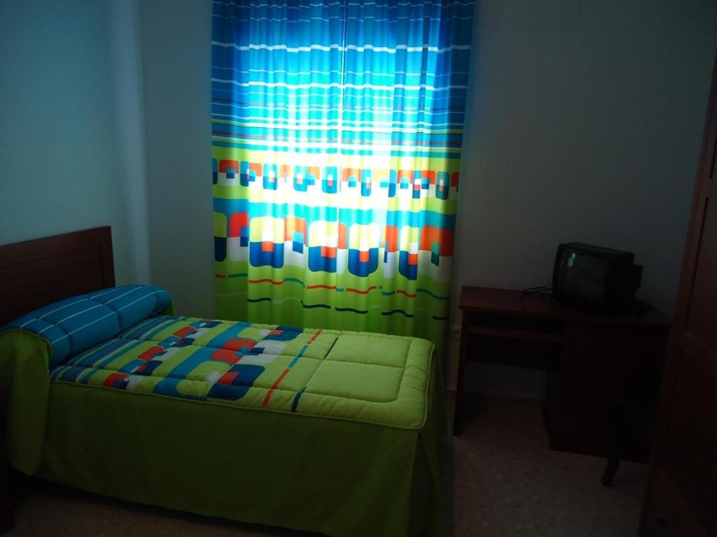 Postel nebo postele na pokoji v ubytování Hostal Los Claveles