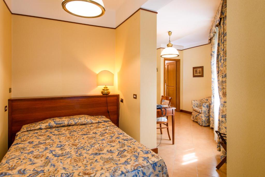 Postel nebo postele na pokoji v ubytování Albergo Reggio