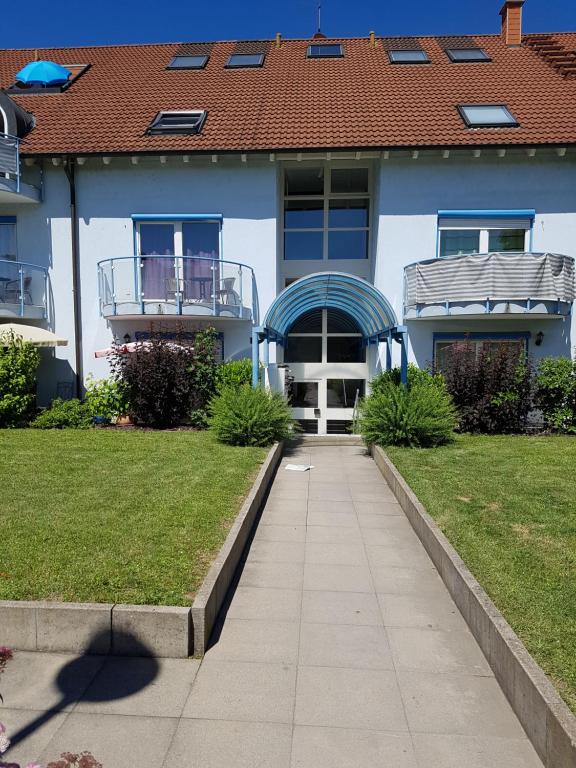 a house with a walkway in front of a yard at Ferienwohnung Zoja in Rust