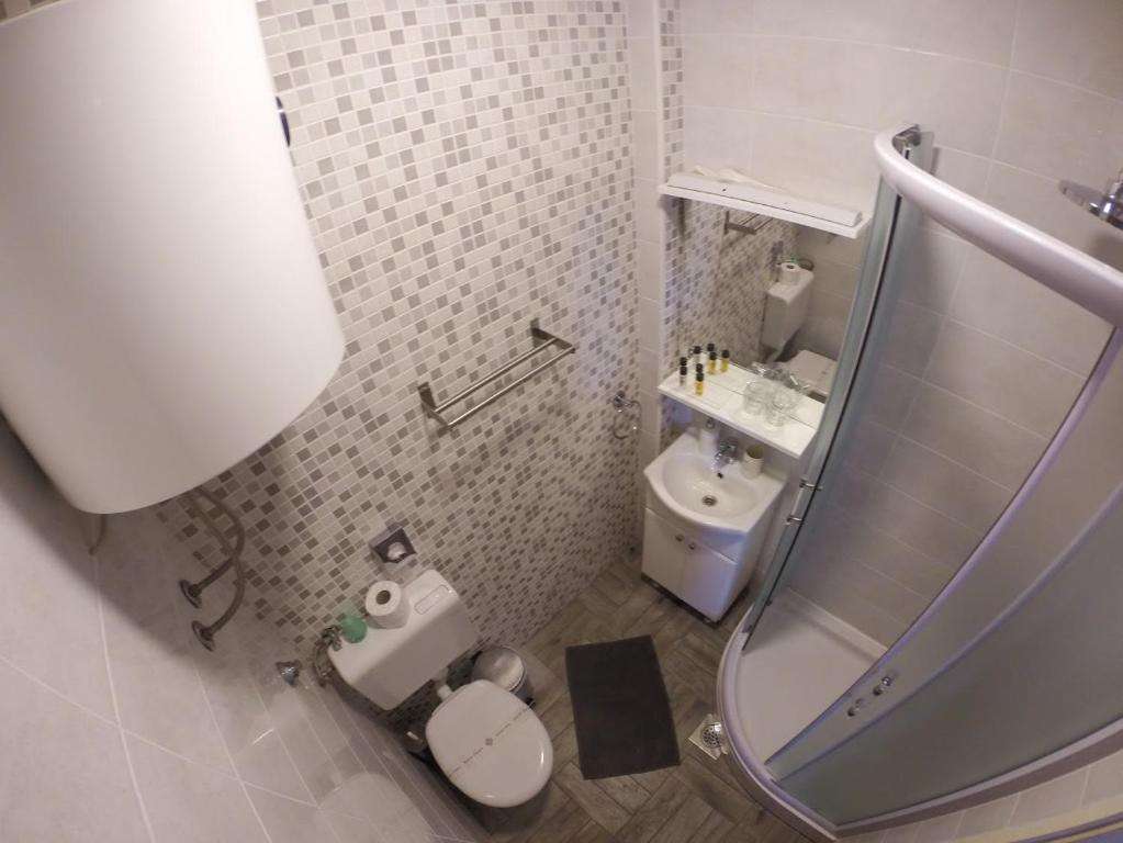 a small bathroom with a toilet and a sink at Apartment and room Sveti Jakov in Dubrovnik