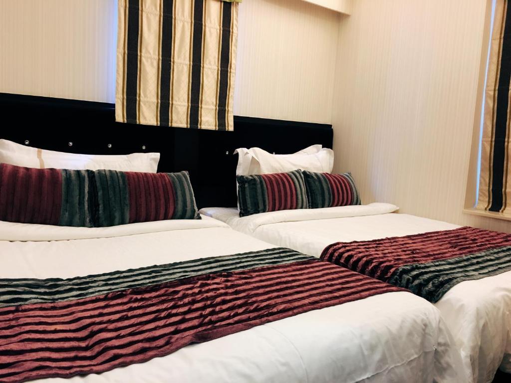 Voodi või voodid majutusasutuse Seasons Hotel - Causeway Bay toas
