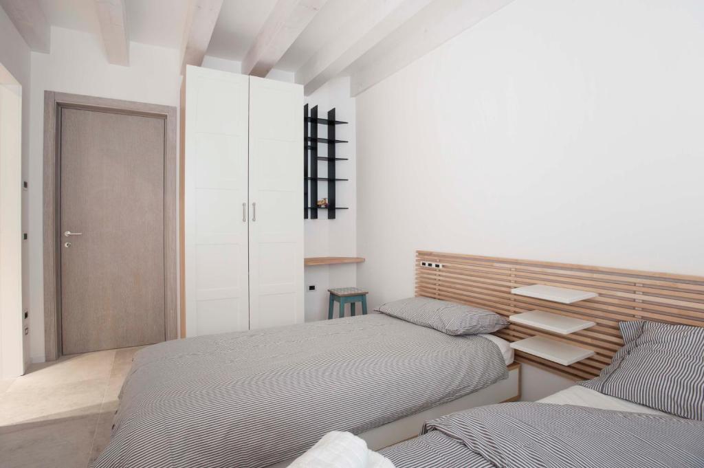 Postel nebo postele na pokoji v ubytování Le Scuderie B&B