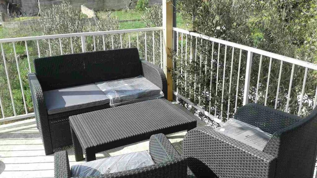 a patio with a table and chairs on a deck at Apartmani Goga in Pirovac