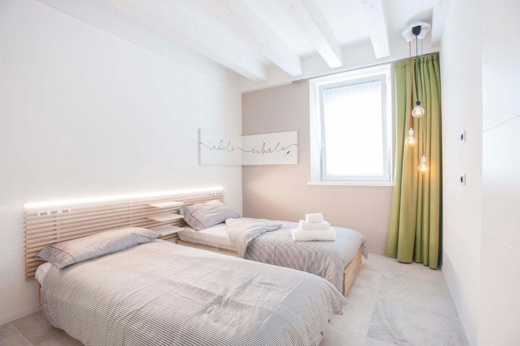 Postel nebo postele na pokoji v ubytování Le Scuderie B&B