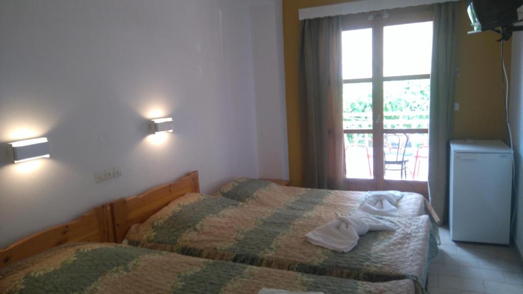 Postel nebo postele na pokoji v ubytování Hotel Aidipsos