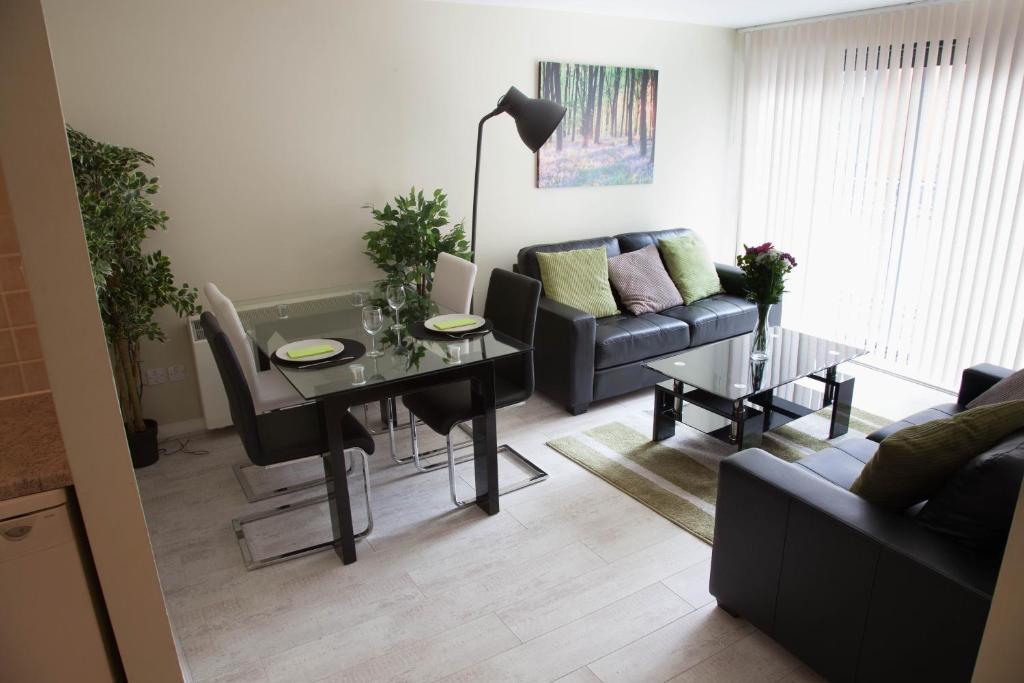 a living room with a table and a couch at City Centre Luxury Holiday Apartment in Liverpool