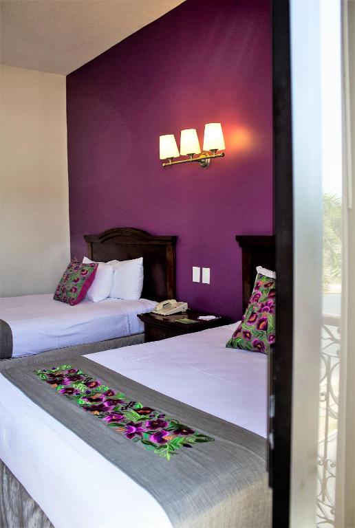 Postel nebo postele na pokoji v ubytování Hotel Plaza Campeche