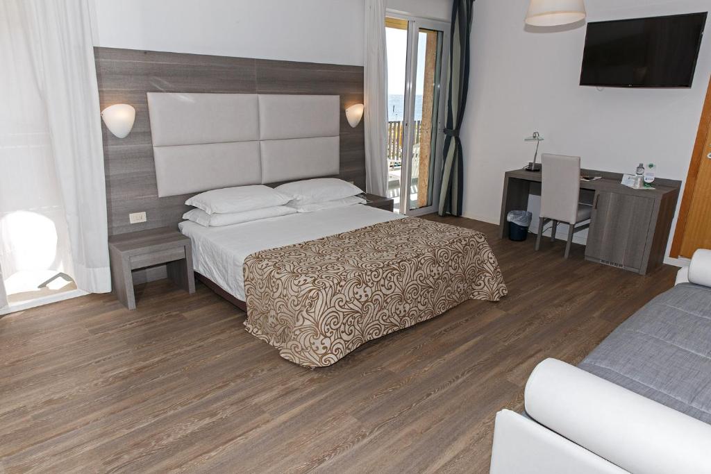 Postel nebo postele na pokoji v ubytování Hotel Sirenetta