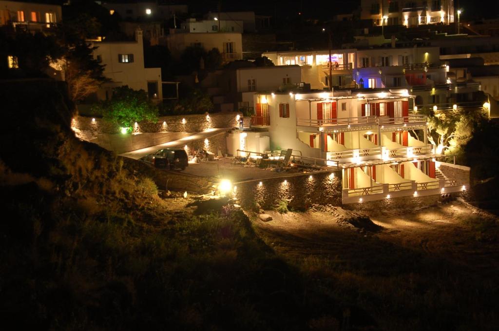 a building lit up at night with lights at Regal View in Mikonos