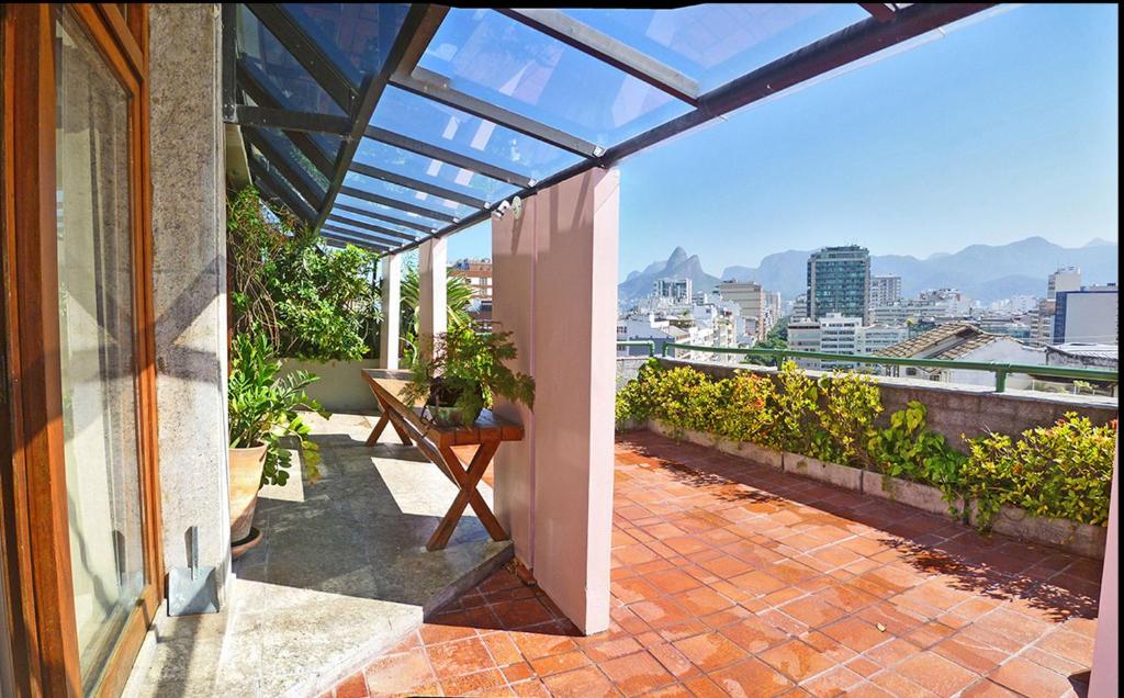 a balcony of a house with a view of the city at Ipanema's Beautiful Penthouse in Rio de Janeiro