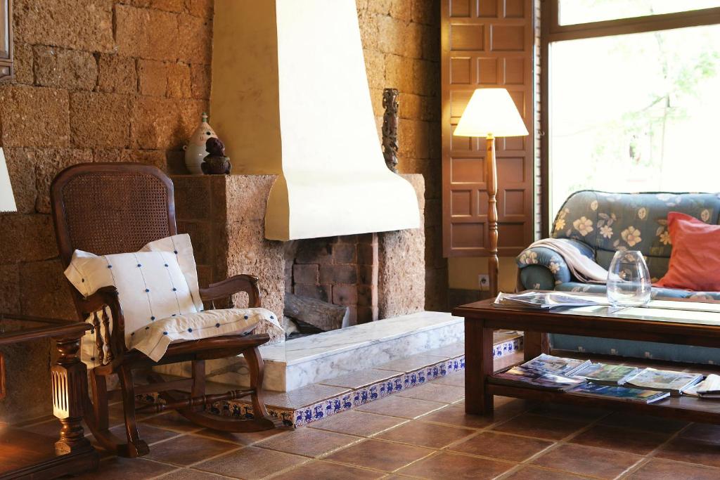 a living room with a couch and a fireplace at Hospedería Santiago in Chiclana de la Frontera