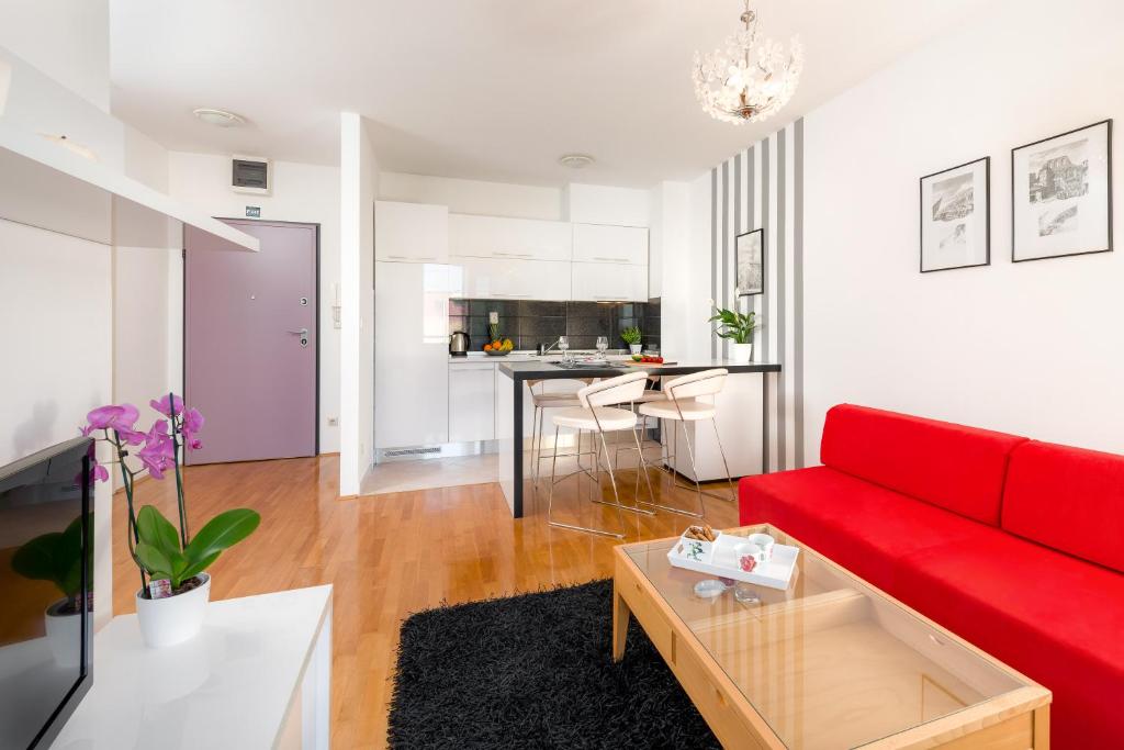 sala de estar con sofá rojo y mesa en City Center Apartment Good Life, en Split