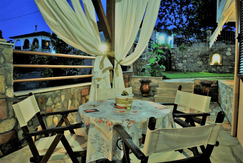 a table and chairs on a patio at night at Voula Kourbeti Apartments in Agios Nikolaos