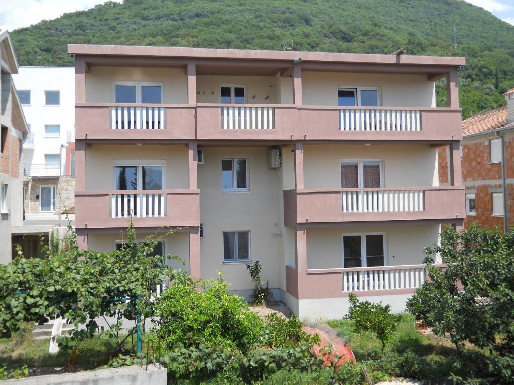 a building with balconies on the side of it at Apartments Mira in Tivat