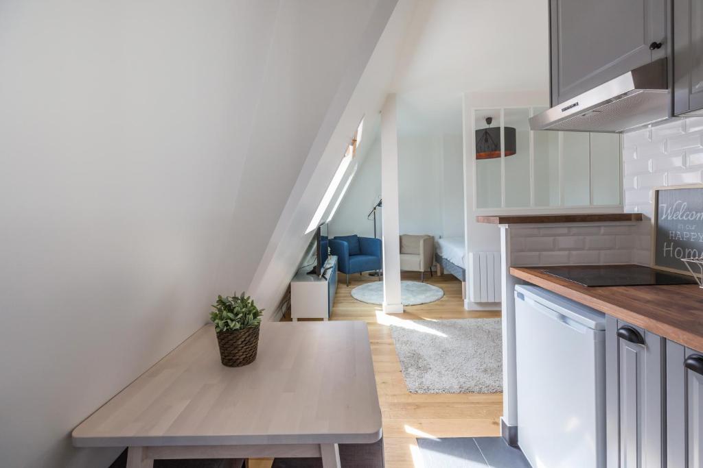a kitchen with a table in the middle of a room at Assas-Vavin Appartements in Paris