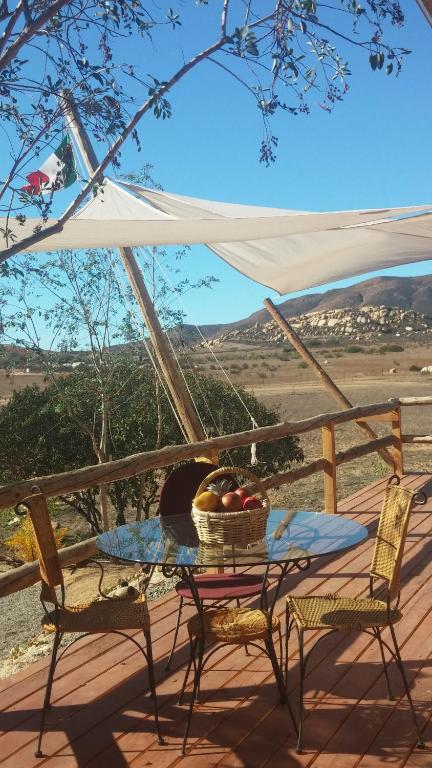 a table with a basket of fruit on a deck at Vinofilia Real Hospitality Inn in Valle de Guadalupe