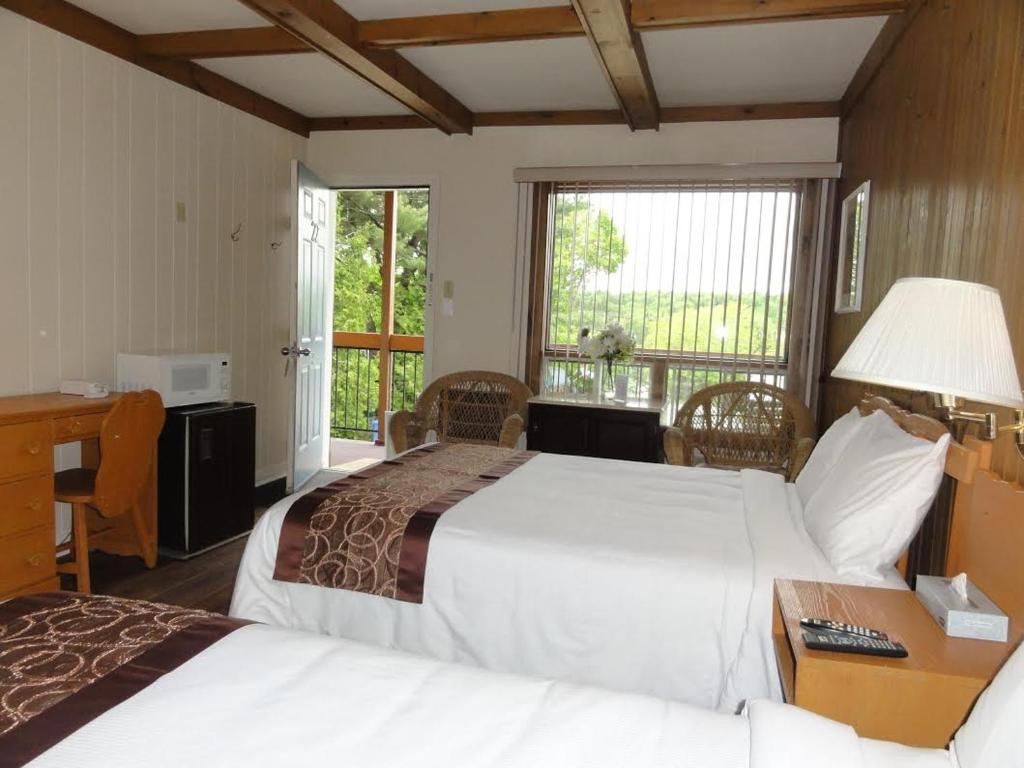 Tempat tidur dalam kamar di Motel Chantolac