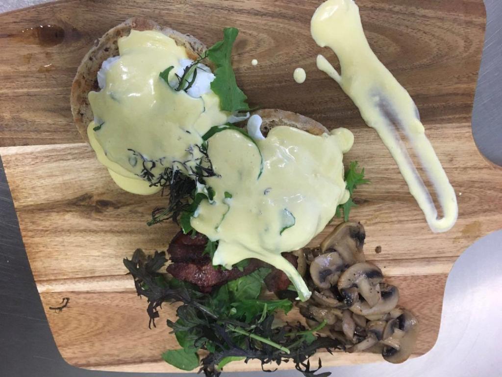 a sandwich with sauce and mushrooms on a cutting board at Allenby Park Hotel in Auckland