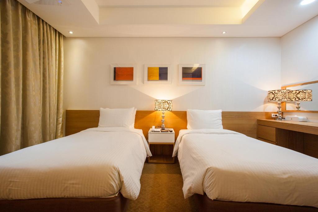 Postel nebo postele na pokoji v ubytování Hotel Pharos
